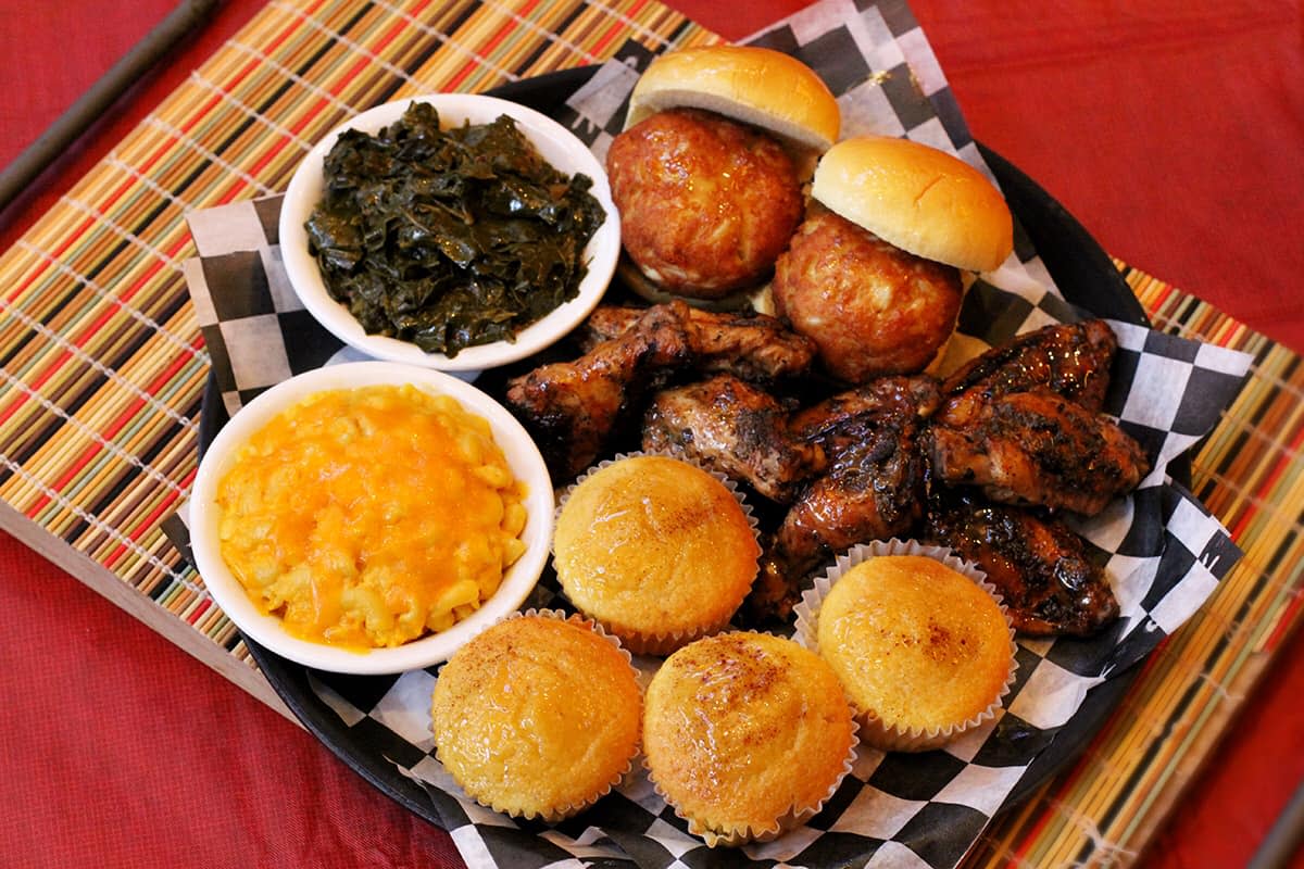 A Carolina Kitchen meal with chicken, greens, macaroni and cheese, and cornbread